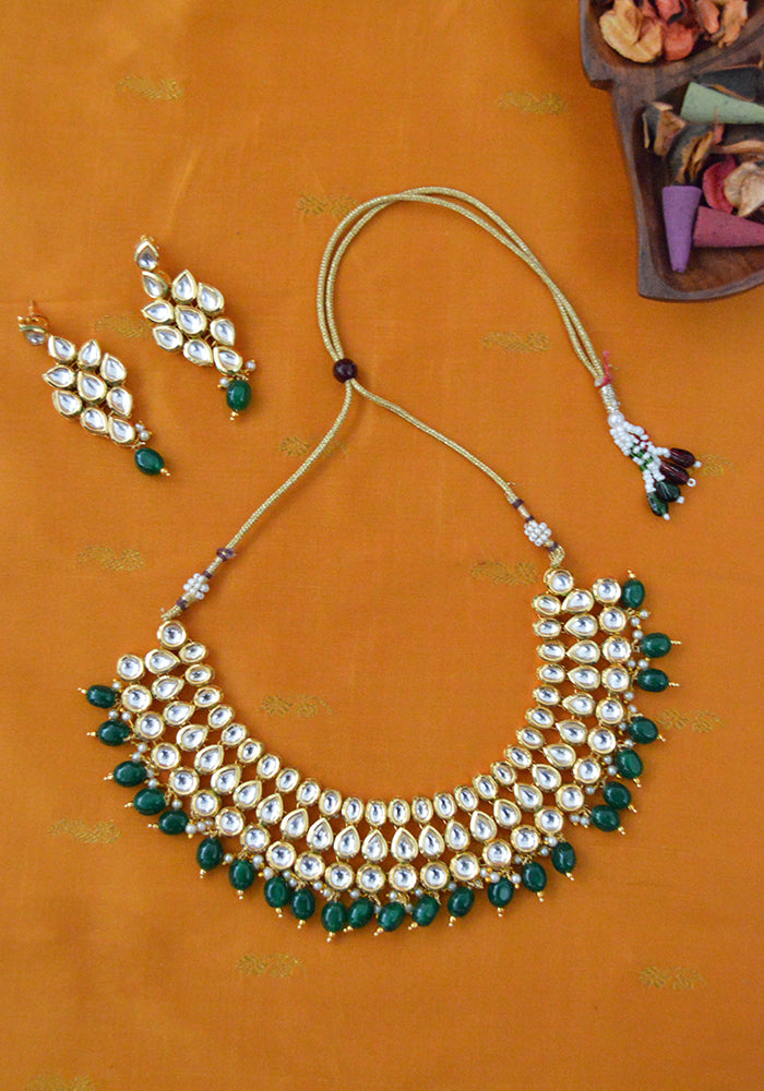 Gold Toned 3 Layered Kundan Necklace with Emerald Color Droplets, Mang Tika and a Pair of Earrings