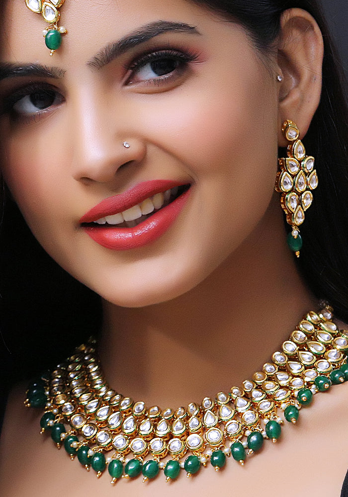 Gold Toned 3 Layered Kundan Necklace with Emerald Color Droplets, Mang Tika and a Pair of Earrings