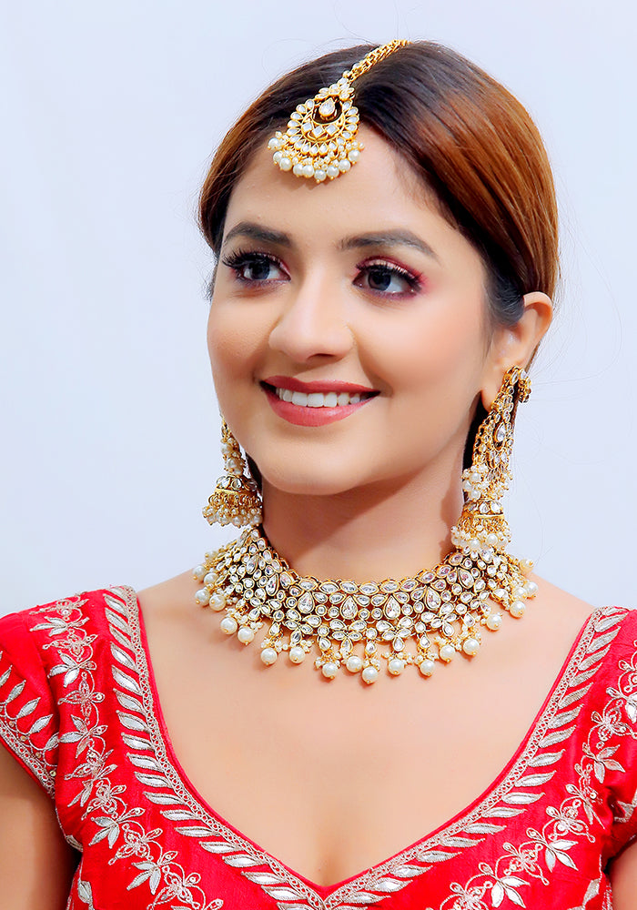 Gold Toned Kundan Necklace with Pearl Droplets, Mang Tika and a Pair of Earrings