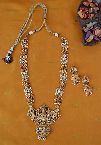 Gold Toned Temple Gold Long Necklace with intricate motifs and a Pair of Jhumkis